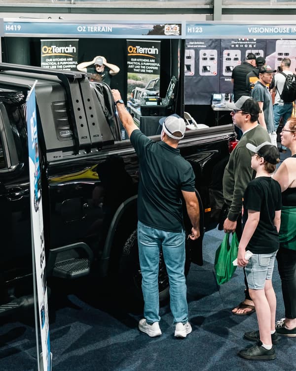 Visitors looking over an RCS canopy on a black ute at the Sydney 4x4 show